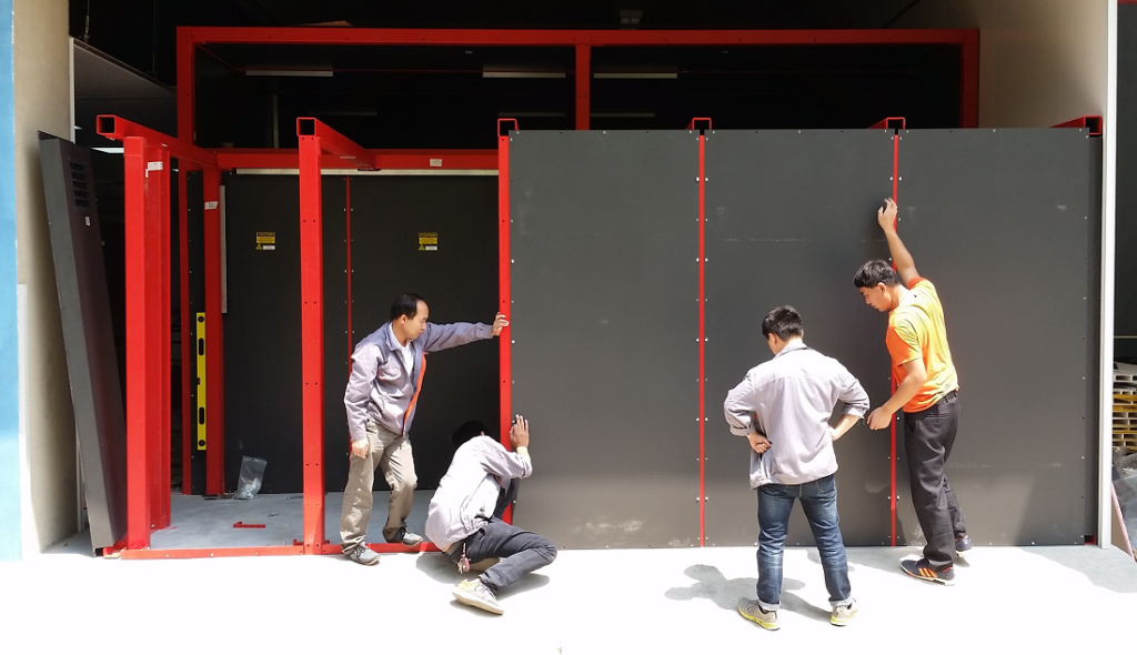 Chinese assembling black panel walls for peening cell from outside perspective