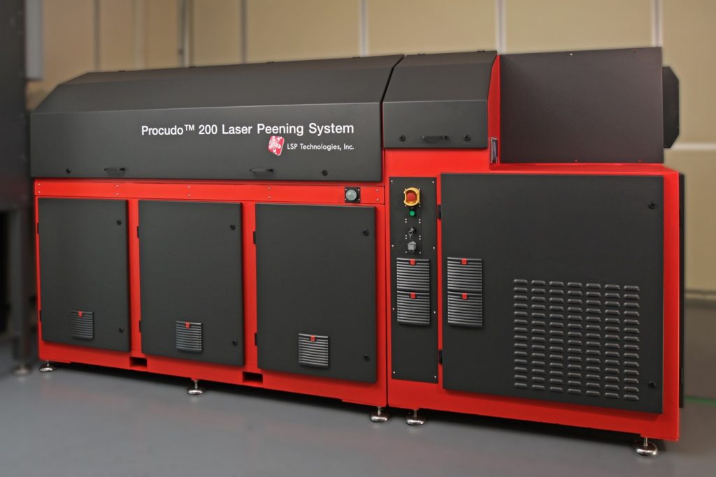 LSP Technologies' Procudo® 200 Laser Peening System laser red and black in small room