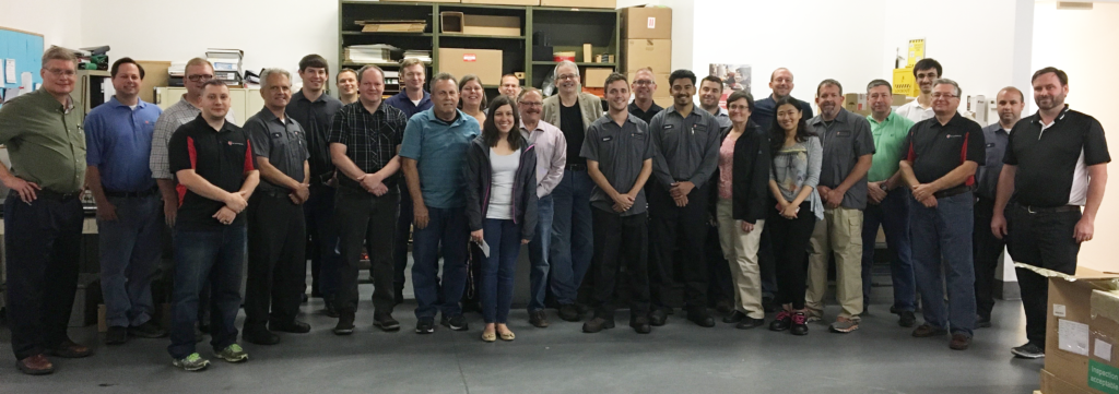 LSPT sfaff posing for group photo in warehouse