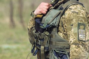 Close up of body armor on solider in green fatigues