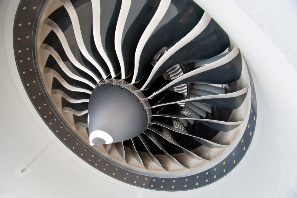 Turbofan engine fan, silver and black curved fan blades