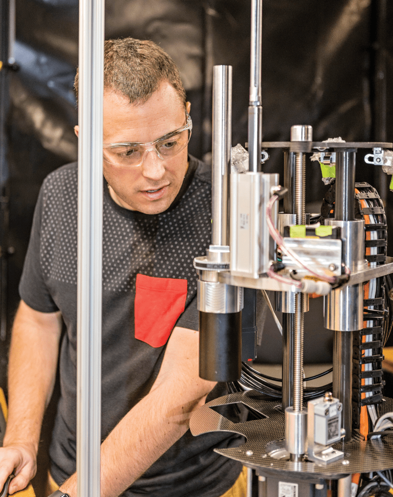 laser peening equipment innovation - LSP Technologies Automation Engineer Anthony Stoner checks controls for a programmable laser beam delivery tool for laser-peening of large components under extreme conditions.