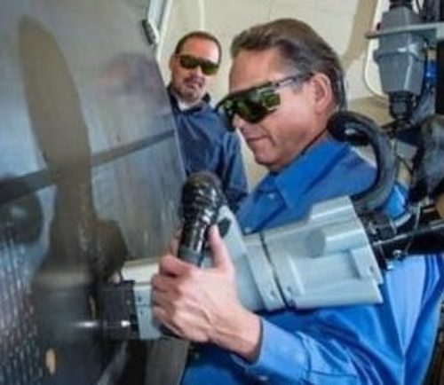 an employee performing a laser bond inspection